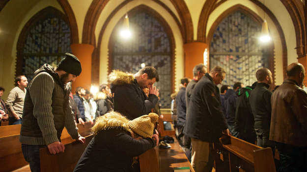 Flüchtlinge, Gemeindemitglieder und ehrenamtliche Helfer bei einer Adventsandacht für syrisch-orthodoxe Christen in der Flüchtlingskirche St. Simeon in Berlin.