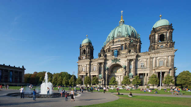 Der Berliner Dom auf der Museumsinsel, im Vordergrund ein Springbrunnen und Besucher