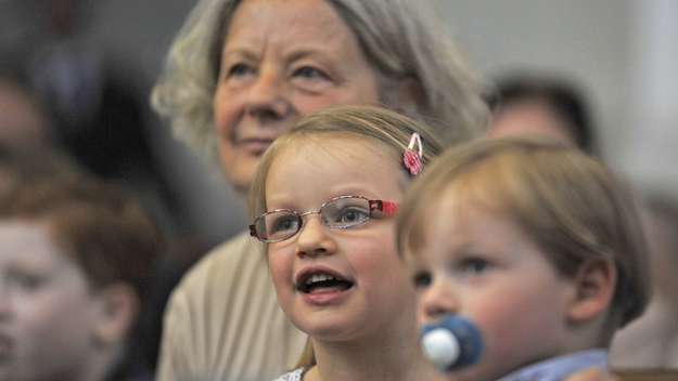 Gottesdienst: Eine Frau und zwei Kinder in den Kirchenbänken