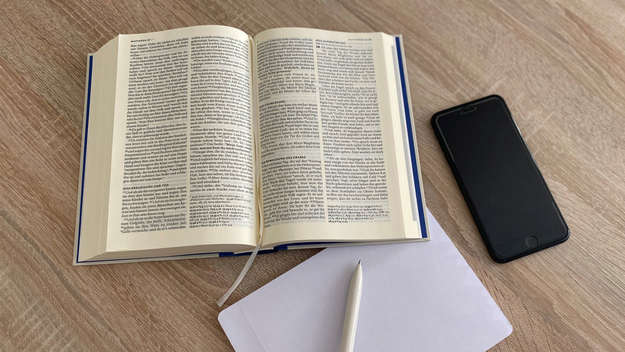 Symbolbild - Aufgeschlagene Bibel. Stift und Zettel