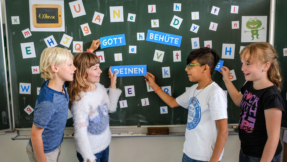 Schülerinnen und Schüler vor einer Tafel Schülerinnen und Schüler vor einer Tafel