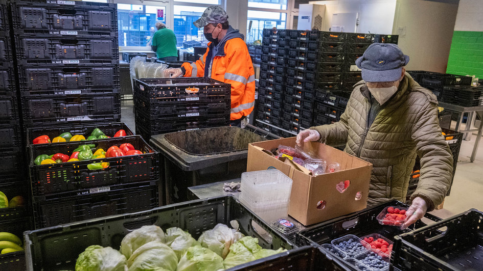Mitarbeiter der Berliner Tafel sortieren frische Lebensmittel zur Ausgabe an Bedürftige