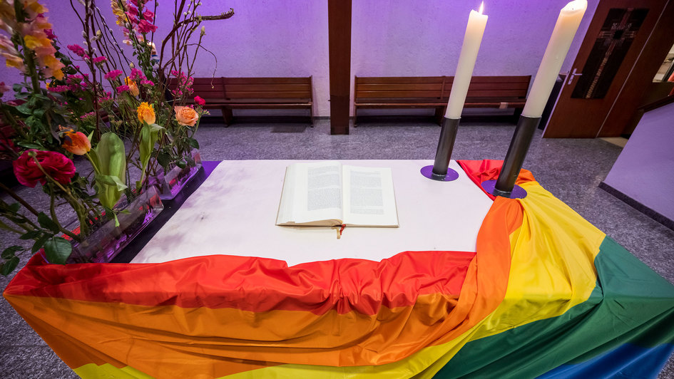Altar mit Regenbogenflagge geschmückt