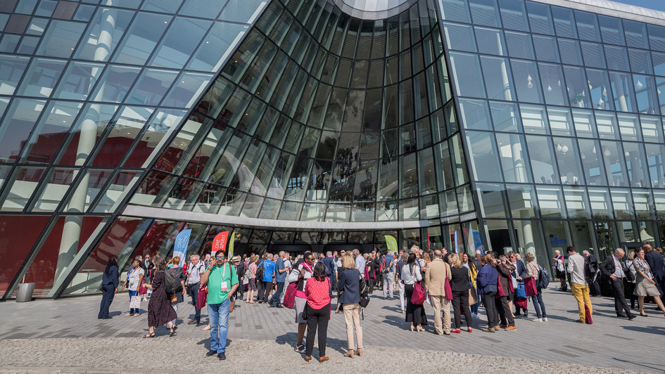Congress center in Krakau - davor stehen Teilnehmer der Versammlung