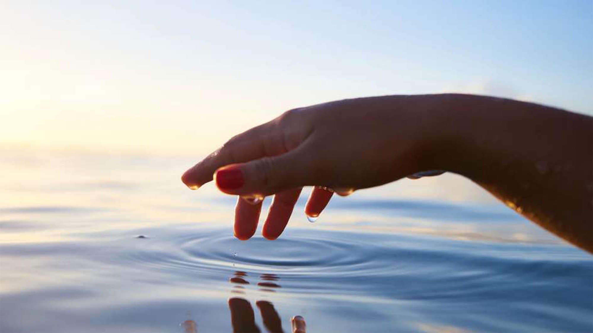 Symbolbild: Eine Hand greift ins Wasser
