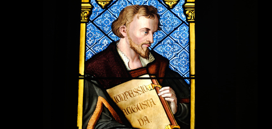 Church window shows Philipp Melanchthon with his 'Confessio Augustana'in the Heidelberger Peterskirche.